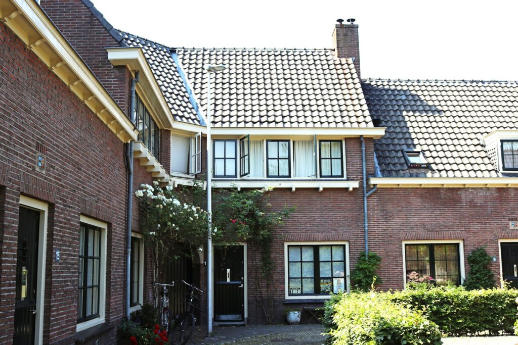 brown brick house with green plants